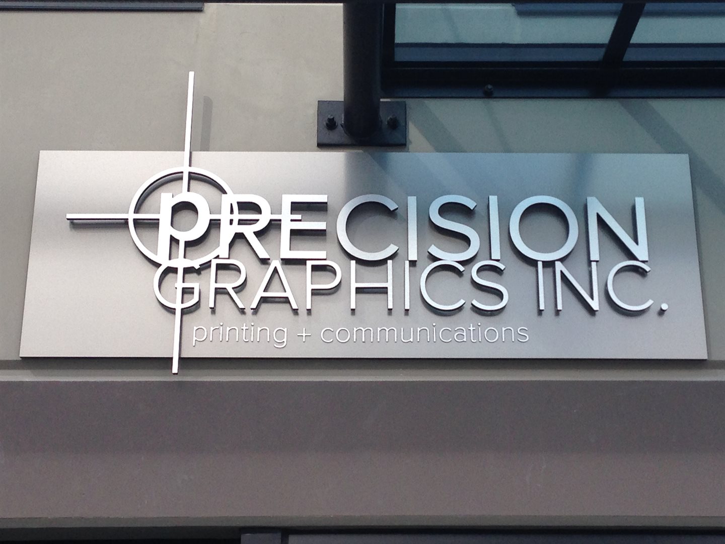 an illuminated storefront sign on a Vancouver commercial building